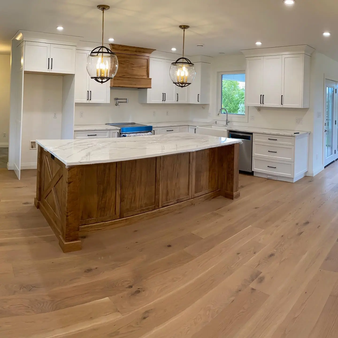 Kitchen with island and hardware cabinetry by Heirlooms Custom Cabinetry