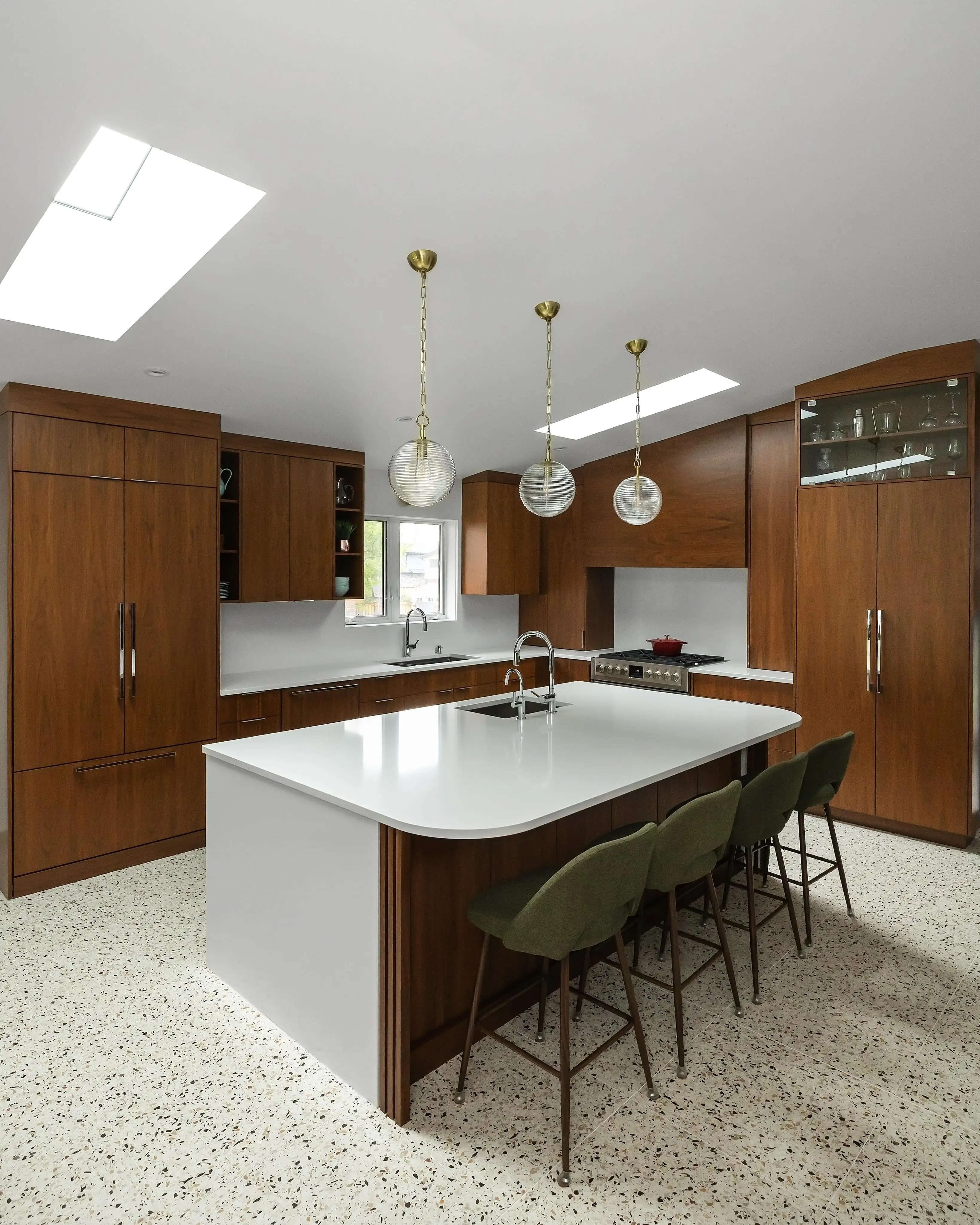 Stained walnut kitchen with range hood cabinetry by Heirlooms Custom Cabinetry