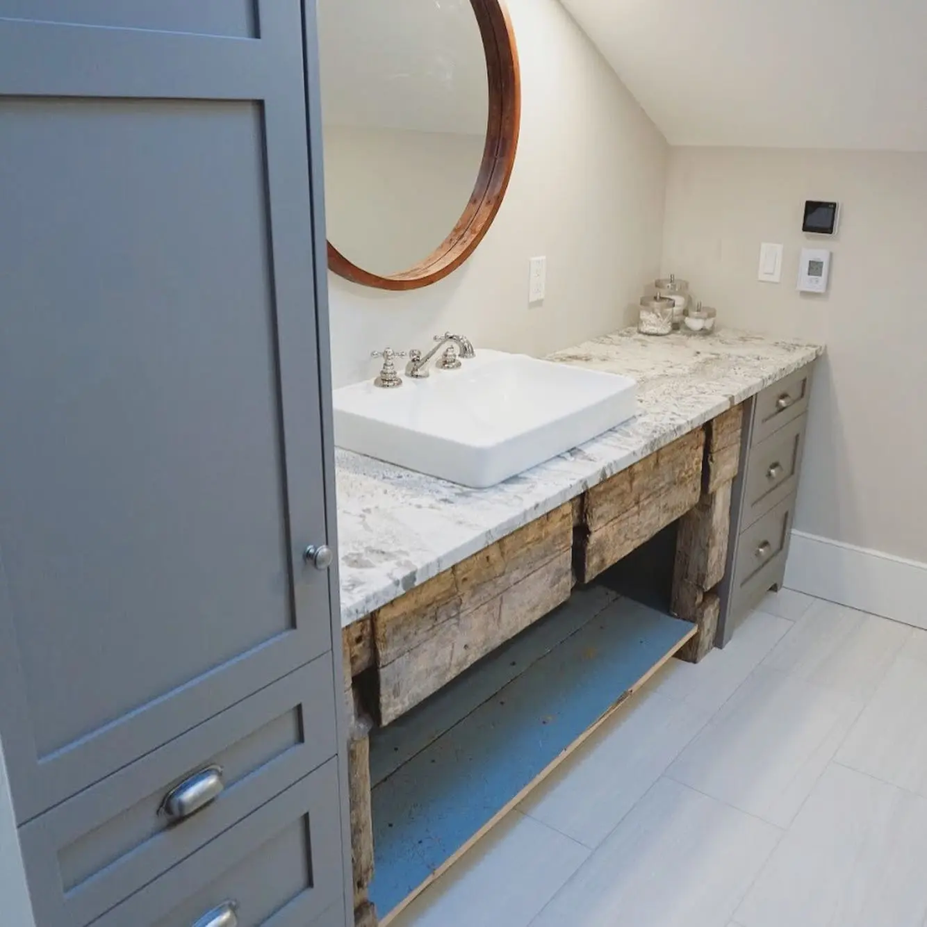 Reclaimed wood vanity with storage and vanity cabinetry by Heirlooms Custom Cabinetry