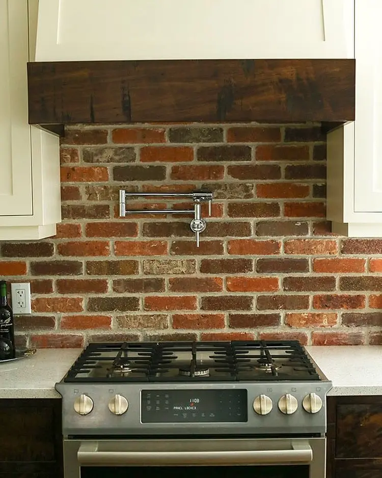 Wood kitchen with pot filler cabinetry by Heirlooms Custom Cabinetry